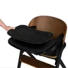 A hand is shown placing a tray onto a wooden high chair. Voir les images du produit