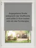 A gray roller blind is shown in a window frame, with text overlaid on the blind itself. The background shows a blurred view of a house and garden. Anteprima dell’immagine prodotto