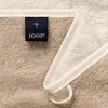 A close-up of a towel with a brand tag. Anteprima dell’immagine prodotto