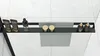 A black shelf with various bathroom products and a towel hanging from it, set against a tiled background. Anteprima dell’immagine prodotto