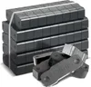 A stack of dark briquettes bound together with a white strap, with a few loose briquettes in the foreground. Produktbild-Vorschau