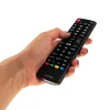 A hand holding a black remote control. Podgląd zdjęcia produktu