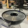 A black kettle grill with a silver insert is displayed in a store. Produktbild-Vorschau