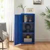 A blue metal cabinet with its door open, showing shelves with decorative items and books. A chair and a plant are visible in the background. Voir les images du produit