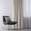 A chair with a pillow next to a curtain. Produktbild-Vorschau