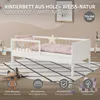 A white wooden cot with natural wood accents, set up in a child's room with bedding and decorative elements. Produktbild-Vorschau