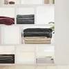Shelves with folded blankets and books. Produktbild-Vorschau