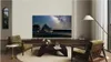 A living room scene with a large TV displaying a starry night sky over a tent. Anteprima dell’immagine prodotto