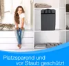 A young girl sits on a dresser in a closet, next to a storage bag. Produktbild-Vorschau