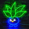 A neon LED light shaped like a cartoon vegetable character is mounted on a brick wall. Podgląd zdjęcia produktu