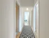 A hallway with a runner rug. Anteprima dell’immagine prodotto