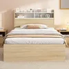 A bedroom scene featuring a bed with a headboard shelf. Náhled obrázku produktu