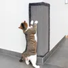 A cat is scratching a corner scratching post attached to a wall. Produktbild-Vorschau