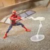 A Spider-Man action figure is posed on a textured surface, appearing to shoot webs. The background suggests an urban rooftop setting. Podgląd zdjęcia produktu