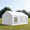 A white party tent is set up on a grassy lawn with trees in the background. Voir les images du produit