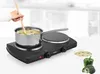 A hand stirring soup in a pot on a portable double burner stove, with a bowl of soup and vegetables next to it. Produktbild-Vorschau