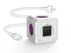 A white cube-shaped power strip with purple accents and black electrical outlets, connected to two power cords with plugs. The product is shown against a white background. Produktbild-Vorschau