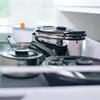 A collection of pots and pans stacked in a drawer. Produktbild-Vorschau