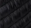 A close-up view of the quilted texture of a black jacket. Produktbild-Vorschau