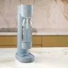 A blue Dafi PushAir saturator with a bottle of water sits on a marble countertop in a kitchen. Podgląd zdjęcia produktu