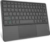 A black wireless Bluetooth keyboard with a touchpad is shown from a slightly elevated front-facing angle against a white background. Produktbild-Vorschau