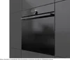 A built-in oven is shown in a modern kitchen setting. Voir les images du produit
