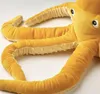 A close-up view of a yellow plush octopus toy. Produktbild-Vorschau
