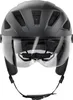 A front view of a black bicycle helmet with a clear visor. Voir les images du produit