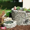 A garden gabion herb spiral with a small pond in the foreground. Produktbild-Vorschau