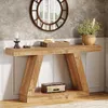 A wooden console table with decorative items on top and a storage box underneath, set against a textured wall and wainscoting. Podgląd zdjęcia produktu