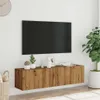 A wall-mounted TV cabinet with a TV mounted above it, in a room setting. Náhľad obrázku produktu