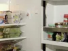 Inside of a refrigerator with shelves filled with food items. Podgląd zdjęcia produktu