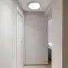 A hallway with a closed door and a ceiling light. Náhľad obrázku produktu