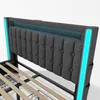 A close-up view of a modern upholstered bed frame with integrated LED lighting. Podgląd zdjęcia produktu