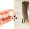 A hand holds a magnetic disc near a toy dishwasher with icons for soap, eco-friendly, and a clock. Náhľad obrázku produktu