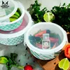Food containers filled with salad and other ingredients, surrounded by fresh produce like radishes, limes, and herbs. Produktbild-Vorschau
