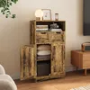 A rustic-style cabinet with open doors, displaying folded textiles and storage baskets, in a living room setting. Produktbild-Vorschau