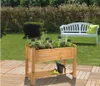 A raised garden bed filled with herbs is shown in a backyard setting, with a white bench in the background. Produktbild-Vorschau