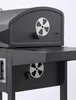A close-up view of a black charcoal grill, focusing on its side details and ventilation controls. Podgląd zdjęcia produktu