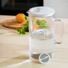 A water filter pitcher with an orange and mint leaves on a wooden cutting board in the background. Anteprima dell’immagine prodotto