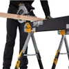 A person is using a circular saw to cut a wooden plank supported by a TOUGHBUILT sawhorse/jobsite table. Anteprima dell’immagine prodotto