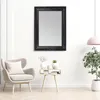 A living room scene with a mirror, armchair, and side table. Produktbild-Vorschau