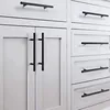 A close-up view of white cabinets and drawers with black bar pulls installed. Produktbild-Vorschau