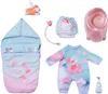A collection of baby doll accessories, including a sleeping bag, outfit, diaper, pacifier clip, and potty. Produktbild-Vorschau
