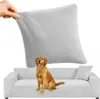 A light gray sofa cover is being stretched by a hand, with a golden retriever sitting on a light gray sofa in the foreground. Podgląd zdjęcia produktu