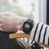 A person wearing a watch sits in a chair. Anteprima dell’immagine prodotto