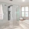 A modern bathroom with a glass-enclosed shower featuring a black shower panel with water running, and a bathtub with stacked towels. Náhľad obrázku produktu
