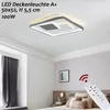 A modern LED ceiling light fixture is shown installed on a white ceiling in a bedroom. A remote control is held in the foreground, pointing towards the light. Produktbild-Vorschau