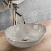 A close-up shot of a marble sink with a golden faucet. Podgląd zdjęcia produktu