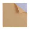A close-up of a brown sheet of paper with a corner curled up, revealing a textured gray surface underneath. Podgląd zdjęcia produktu